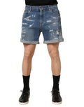 Dolce & Gabbana blue cotton distressed denim Bermuda shorts with frayed edges and casual fit.