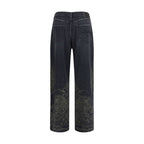 R13 black cotton denim jeans with a slim fit and classic five-pocket design, shown on a model.