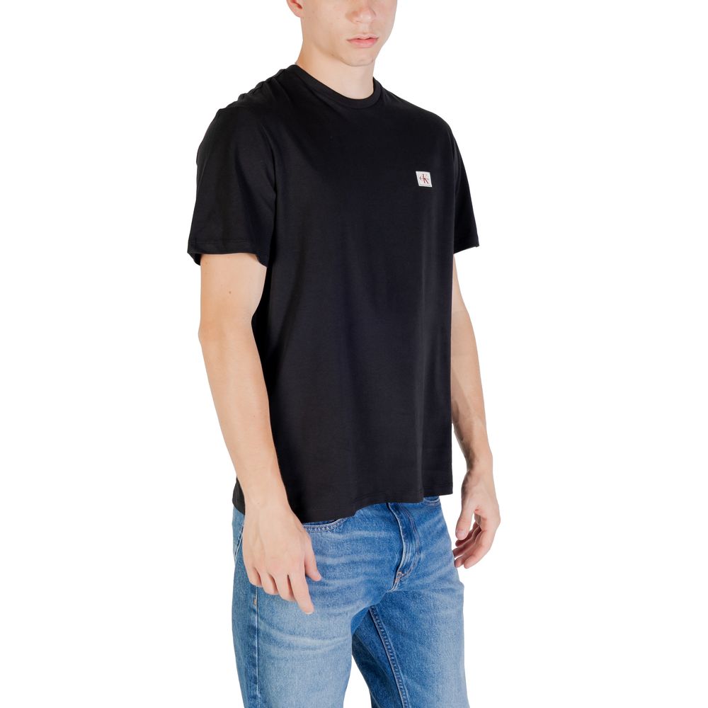 Black cotton T-shirt from Calvin Klein Jeans with classic logo design and short sleeves, displayed on a plain background.