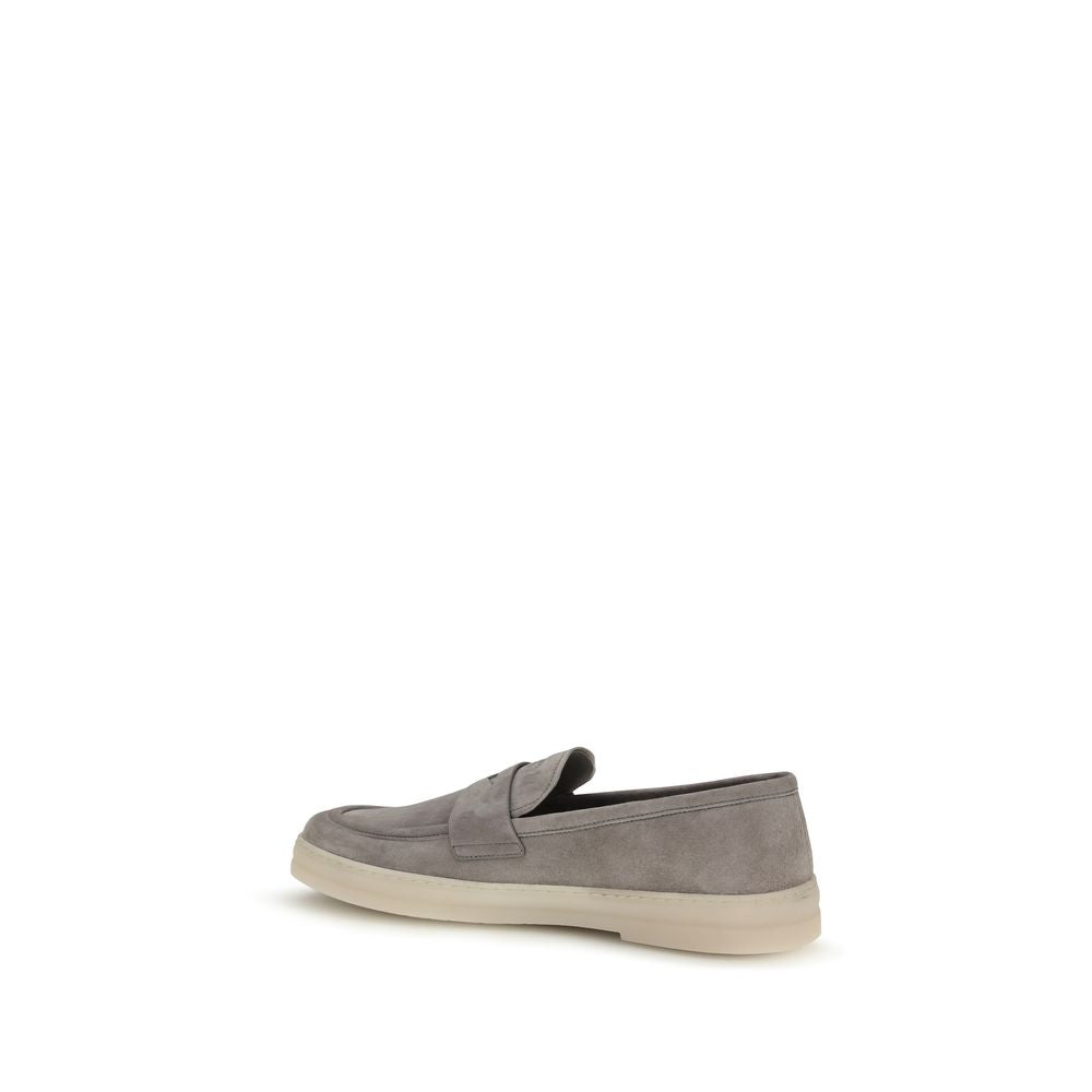 Prada gray calf leather Bos Taurus slip-on loafers with sleek design and subtle stitching, showcasing the elegant footwear style.