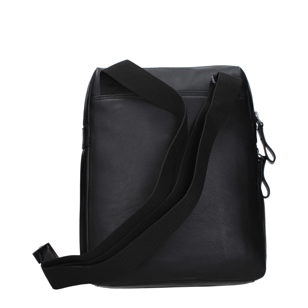 Piquadro black leather crossbody bag with adjustable strap, front pockets, and sleek design for everyday use.