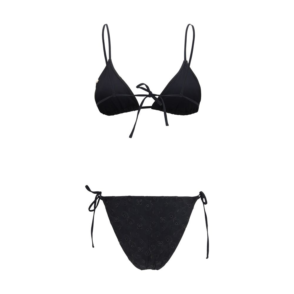 Kristina Ti black polyester bikini top with adjustable straps and supportive design, shown on a model.