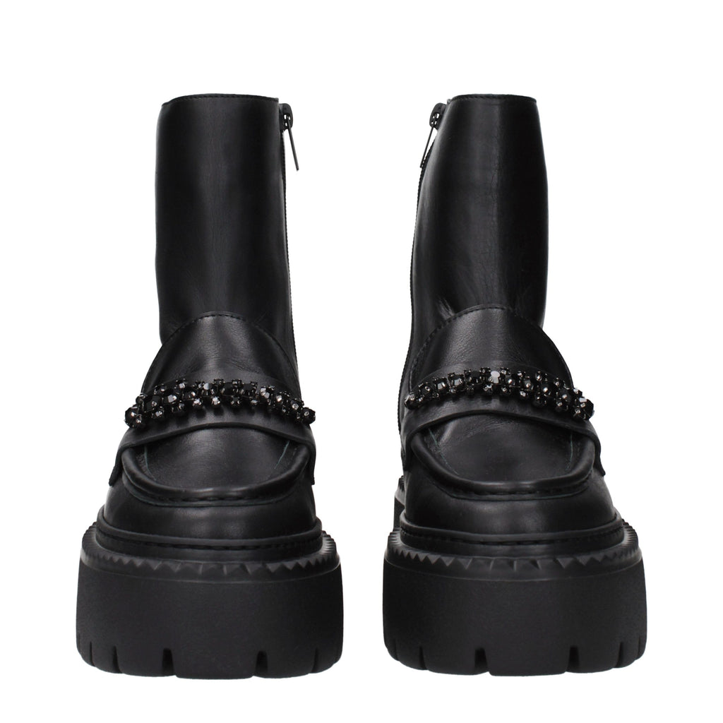 Black leather Jimmy Choo ankle boots with sleek design and pointed toes, stylish footwear for modern fashion.