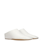 White leather slippers by Jil Sander featuring a sleek, minimalist design and comfortable slip-on style.