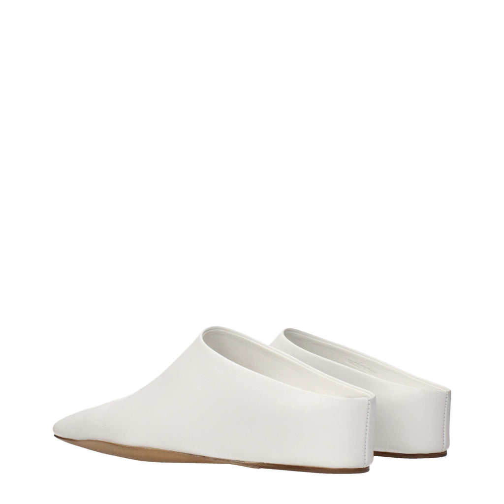 White leather slippers by Jil Sander featuring a sleek, minimalist design and comfortable slip-on style.