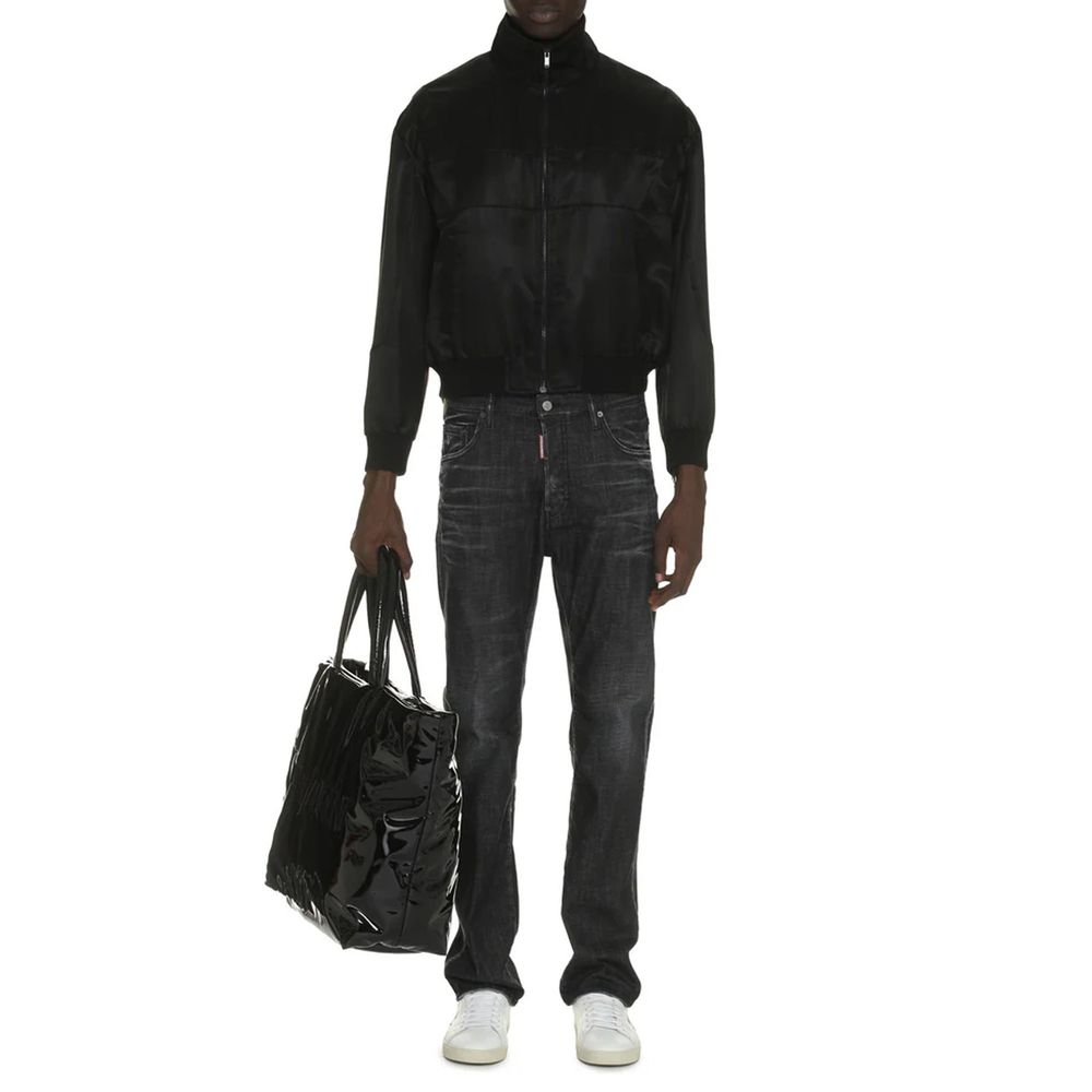 Saint Laurent black silk bomber jacket with a sleek design and ribbed cuffs, displayed on a neutral background.