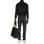 Saint Laurent black silk bomber jacket with a sleek design and ribbed cuffs, displayed on a neutral background.