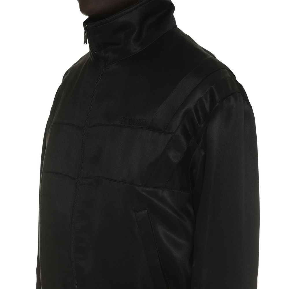 Saint Laurent black silk bomber jacket with a sleek, smooth finish and classic fit, shown on a model.