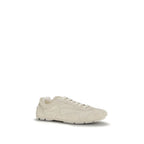 Prada beige calf leather Bos Taurus sneakers with white soles and minimalist design, showcasing luxury sneaker craftsmanship.