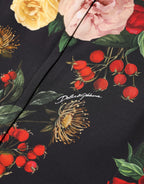 Dolce & Gabbana black floral crepe blouse with frill detail, showcasing elegant long sleeves and intricate floral pattern.