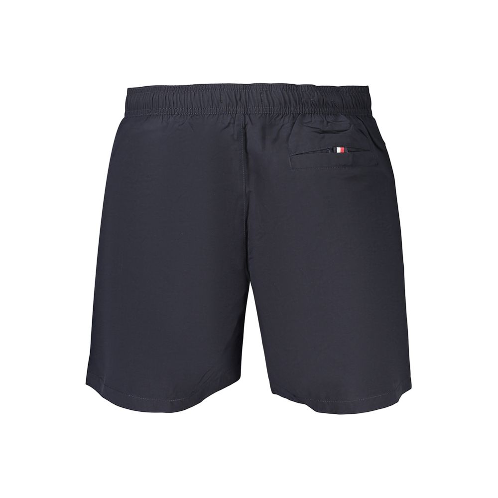 Tommy Hilfiger men's blue polyester shorts with an elastic waistband and side pockets, casual summer apparel.