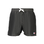 Tommy Hilfiger black polyester men's swimwear with logo waistband, front view showing sleek design and comfortable fit.