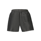 Tommy Hilfiger black polyester men's swimwear with classic logo waistband and sleek design, suitable for beach or pool days.