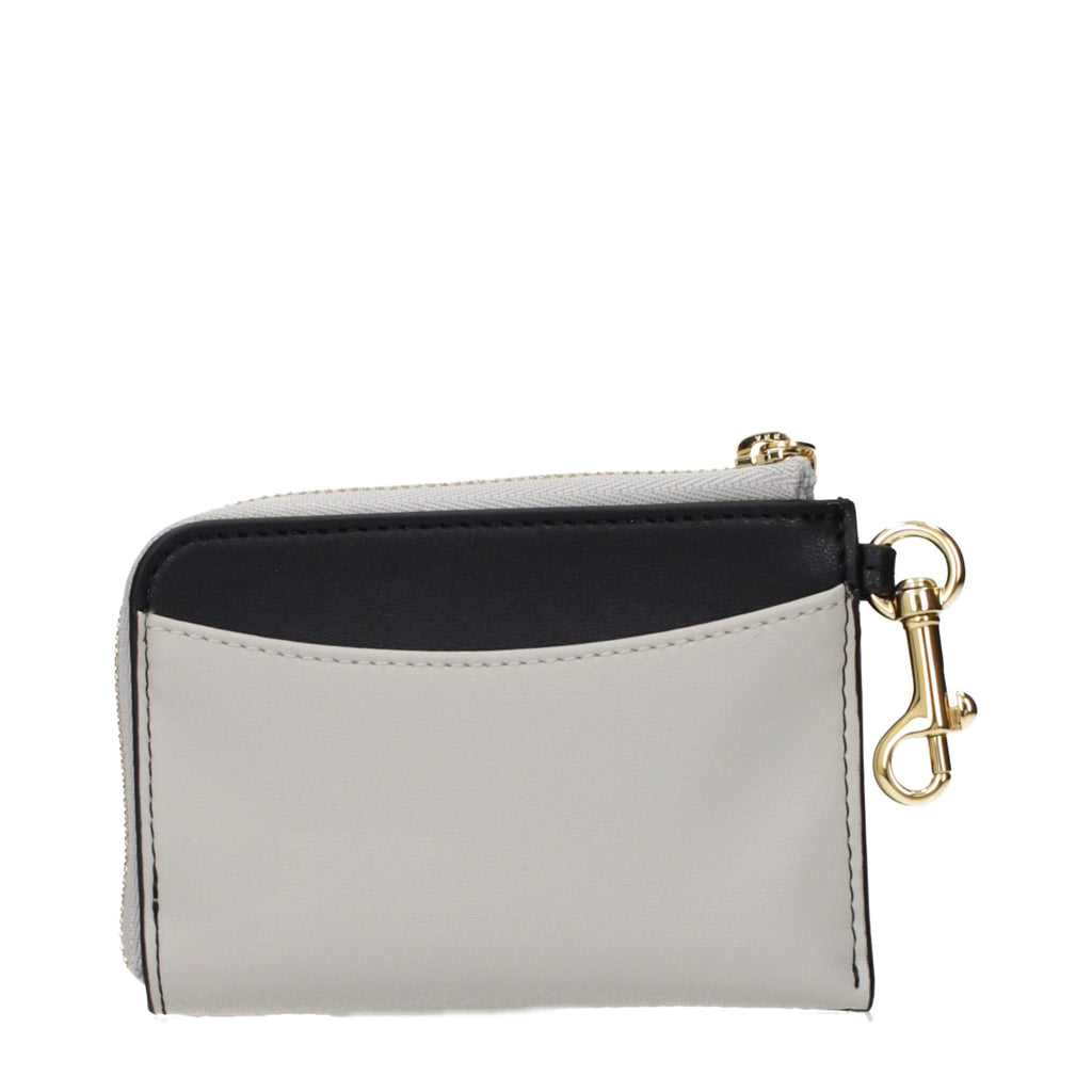 Stella McCartney black leather wallet with sleek design and subtle branding, featuring multiple card slots and a zip coin pocket.