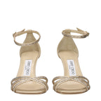 Beige satin stiletto heel sandals by Jimmy Choo with elegant straps and a sleek, polished design.