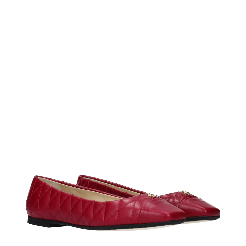 Jimmy Choo pink leather ballet flats with rounded toe and sleek design on a neutral background.