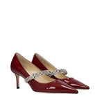 Red leather Jimmy Choo high heel pumps with pointed toes and sleek design for elegant footwear.
