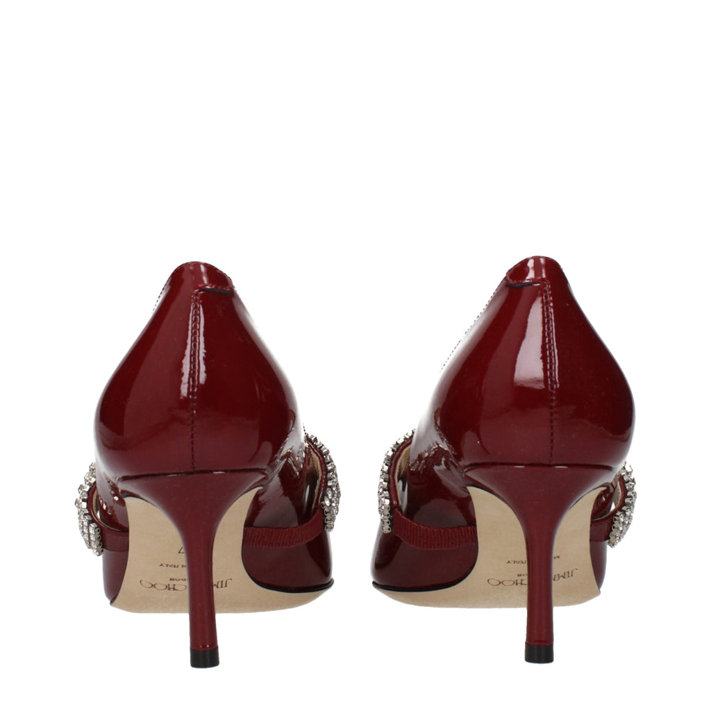 Red leather high heel pumps by Jimmy Choo featuring sleek pointed toes and elegant stiletto heels.
