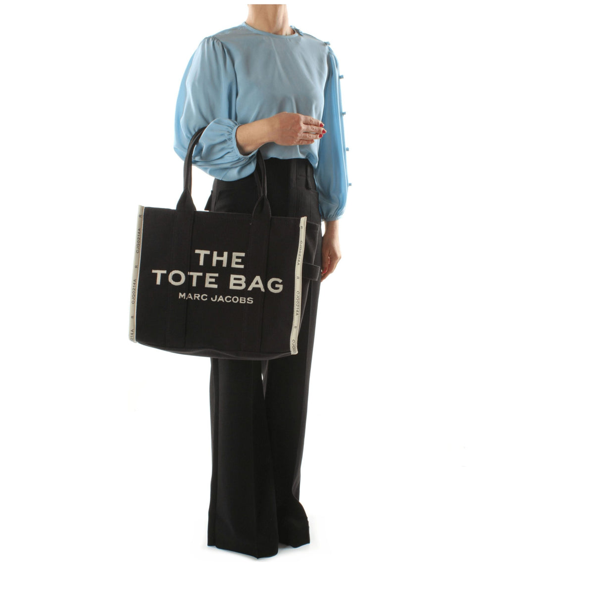 Black fabric shoulder bag by Marc Jacobs with adjustable strap and minimalist design, ideal for everyday use.