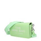 Green leather crossbody bag by Marc Jacobs with adjustable strap and gold-tone hardware, styled for casual or chic outfits.