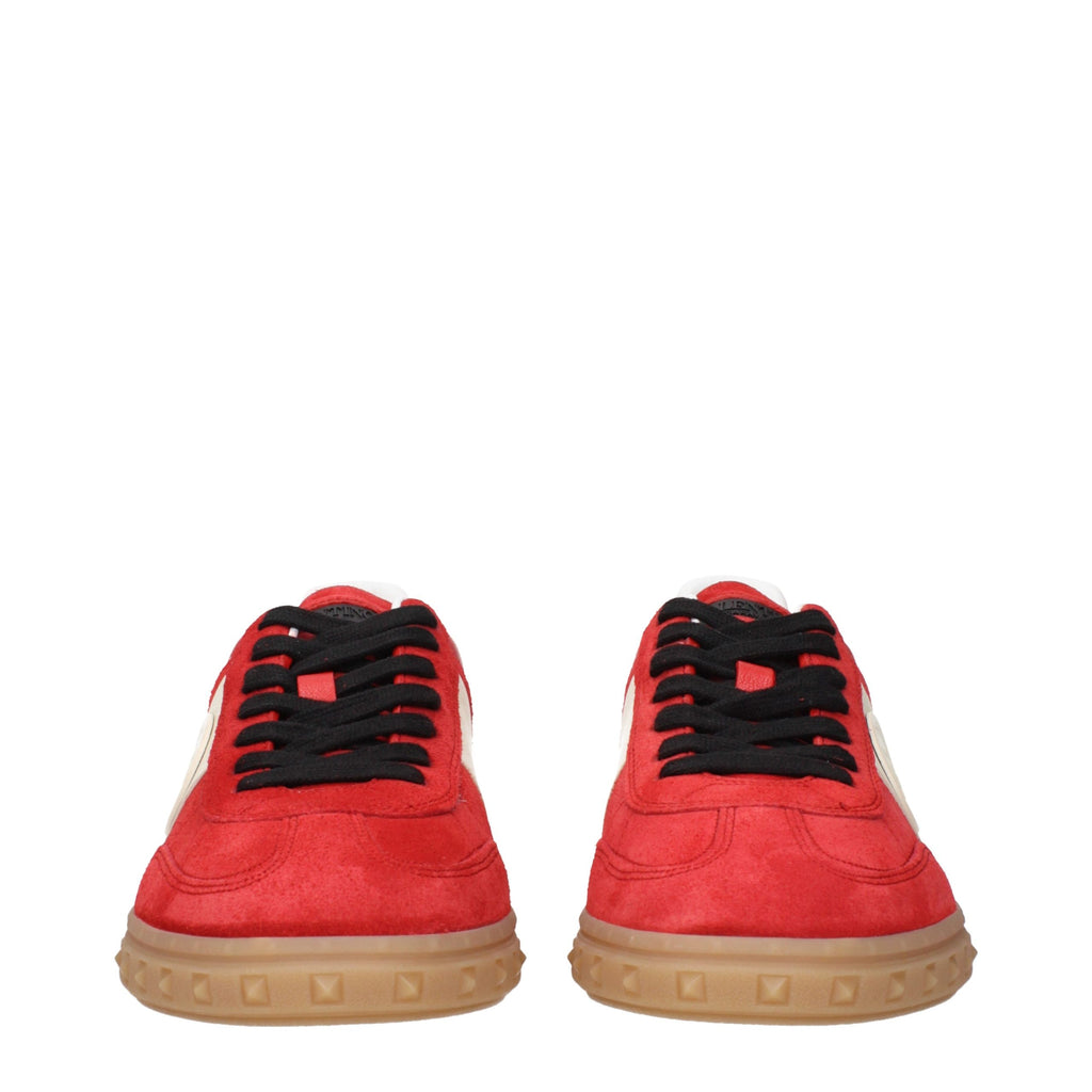 Valentino Garavani red leather low top sneakers with white rubber soles and subtle logo accents on the sides.
