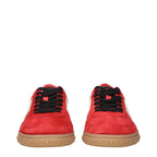 Valentino Garavani red leather low top sneakers with white rubber soles and subtle logo accents on the sides.