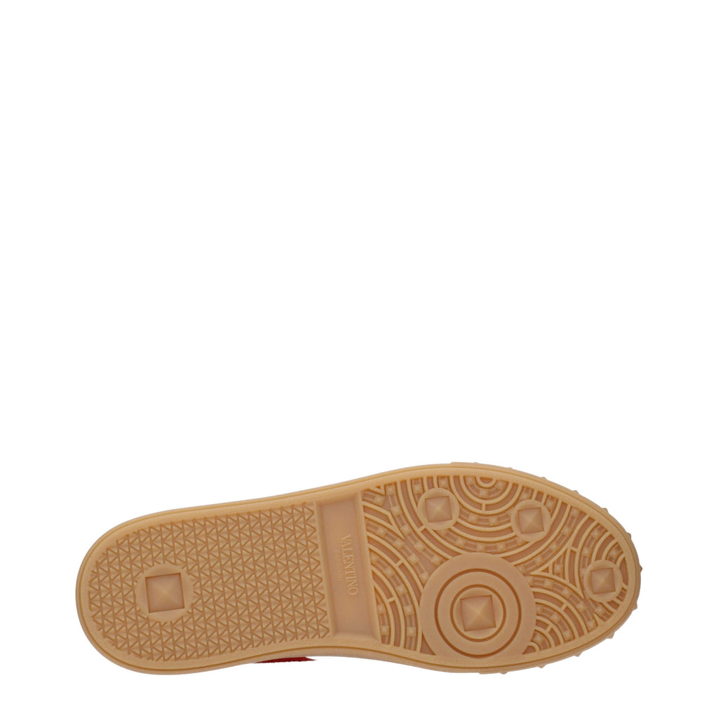 Red leather Valentino Garavani low top sneakers with white soles and subtle branding, stylish and comfortable for casual wear.