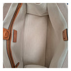 Valentino Garavani beige fabric handbag with elegant design and subtle branding, featuring a structured shape and top handles.