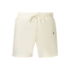 Beige polyester men's shorts by Tommy Hilfiger with a relaxed fit and adjustable waistband, shown on a model.