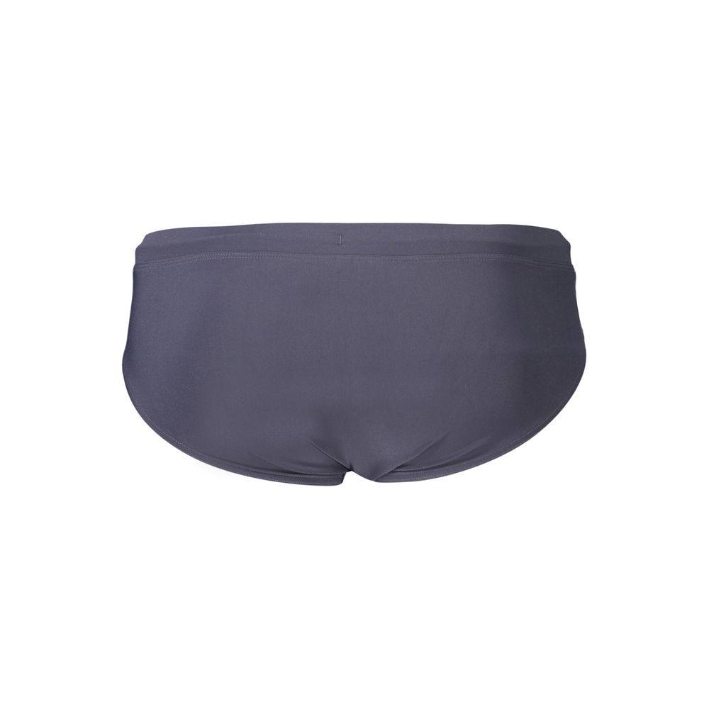 Tommy Hilfiger men's blue polyester swimwear shorts with logo detail, suitable for beach or poolside swimming.