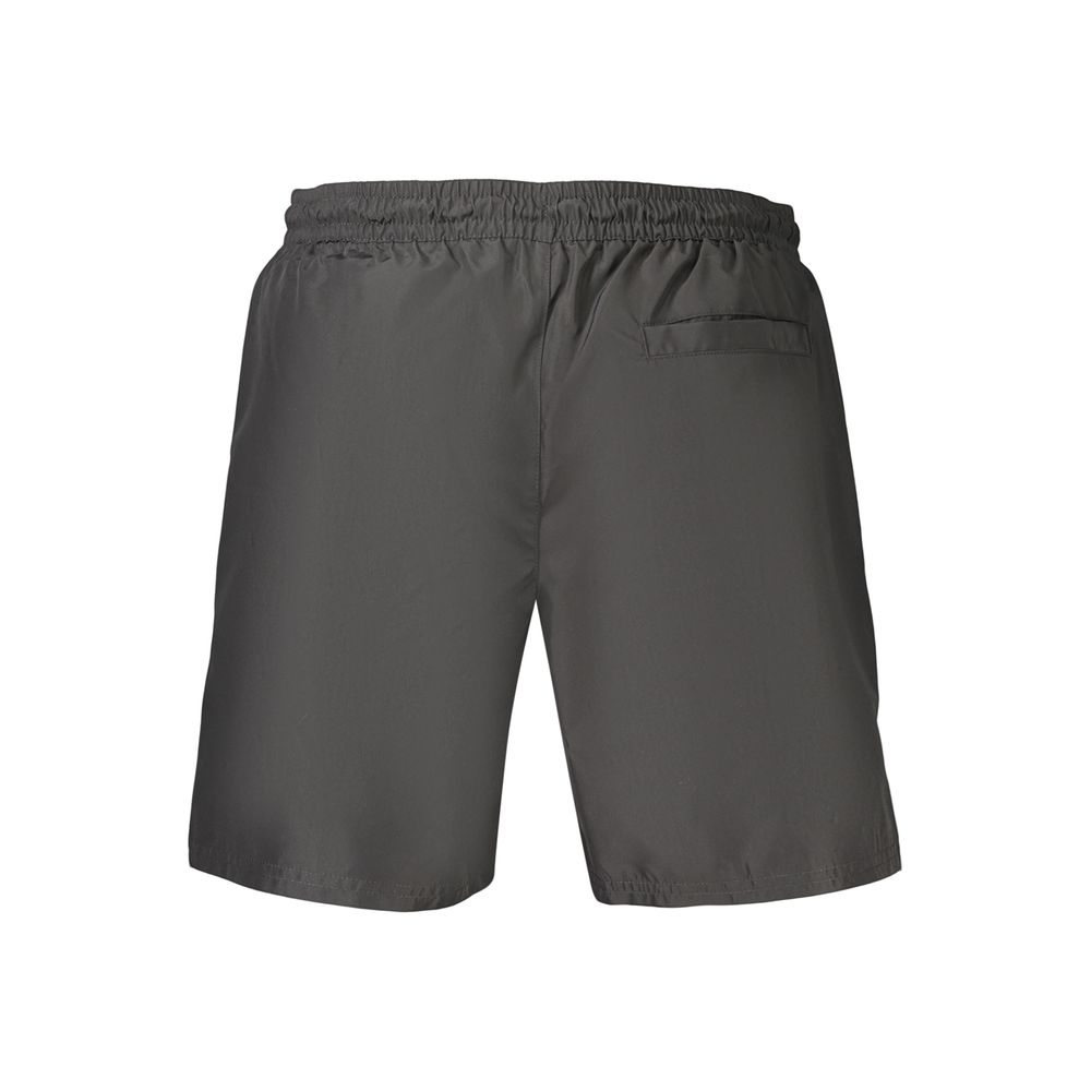 Black Calvin Klein men's swimwear made of polyester, featuring a sleek design and comfortable fit for beach or pool.