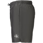 Black Calvin Klein men's polyester swimwear with a sleek design, featuring the brand logo on the waistband.