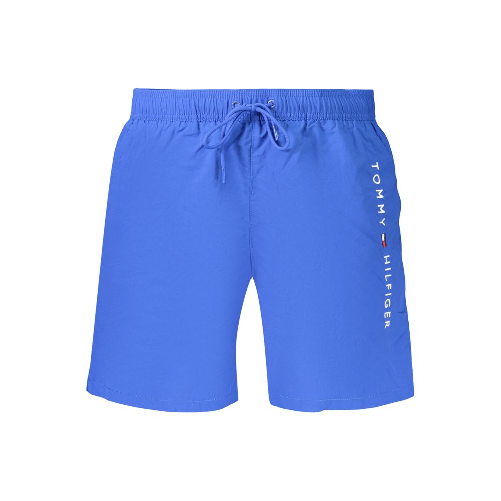 Tommy Hilfiger men's blue polyester shorts displayed on a hanger, featuring a casual fit and brand logo detail.