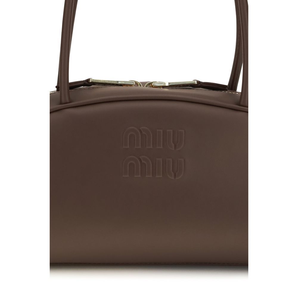 Miu Miu brown calf leather Bos Taurus shoulder bag with gold-tone hardware and adjustable strap.