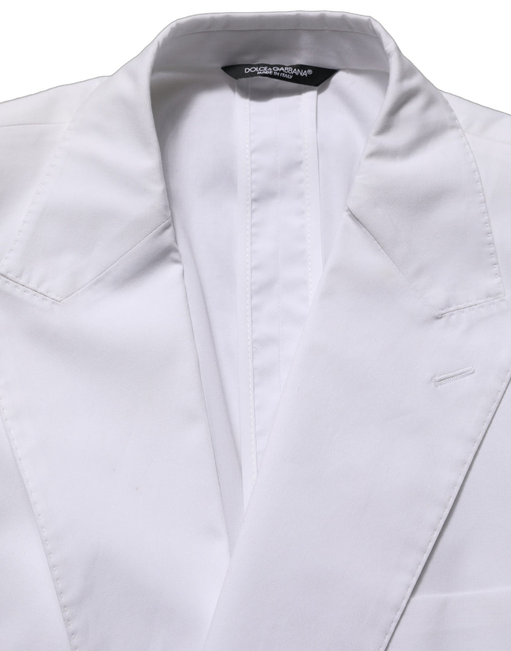 Dolce & Gabbana white cotton double-breasted blazer jacket with structured fit and classic lapel, displayed on a hanger.