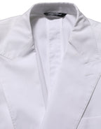Dolce & Gabbana white cotton double-breasted blazer jacket with structured fit and classic lapel, displayed on a hanger.