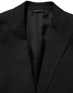 Dolce & Gabbana black polyester single-breasted blazer jacket displayed on a hanger with a tailored fit and classic lapel.