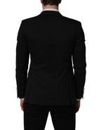 Dolce & Gabbana black polyester blazer jacket with single-breasted design and notch lapel, displayed on a hanger.
