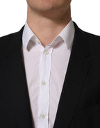 Black wool Dolce & Gabbana single-breasted blazer jacket with notch lapels and tailored fit, shown on a hanger.