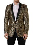 Dolce & Gabbana gold leopard print single-breasted men's coat jacket displayed on a hanger.