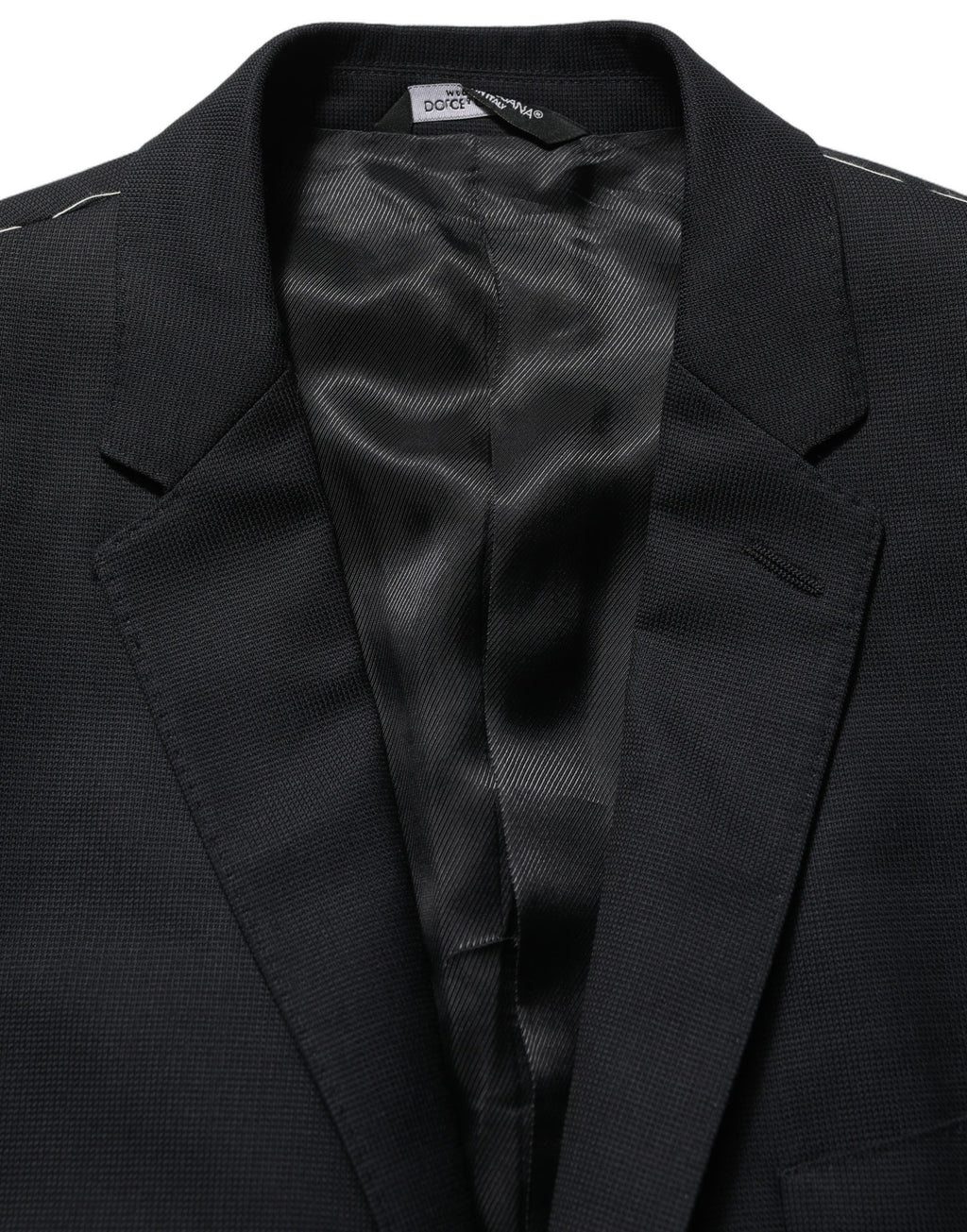 Dark blue wool Dolce & Gabbana single-breasted blazer jacket with notch lapels and button closure, tailored fit for a sophisticated look.