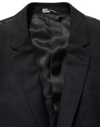 Dark blue wool Dolce & Gabbana single-breasted blazer jacket with notch lapels and button closure, tailored fit for a sophisticated look.