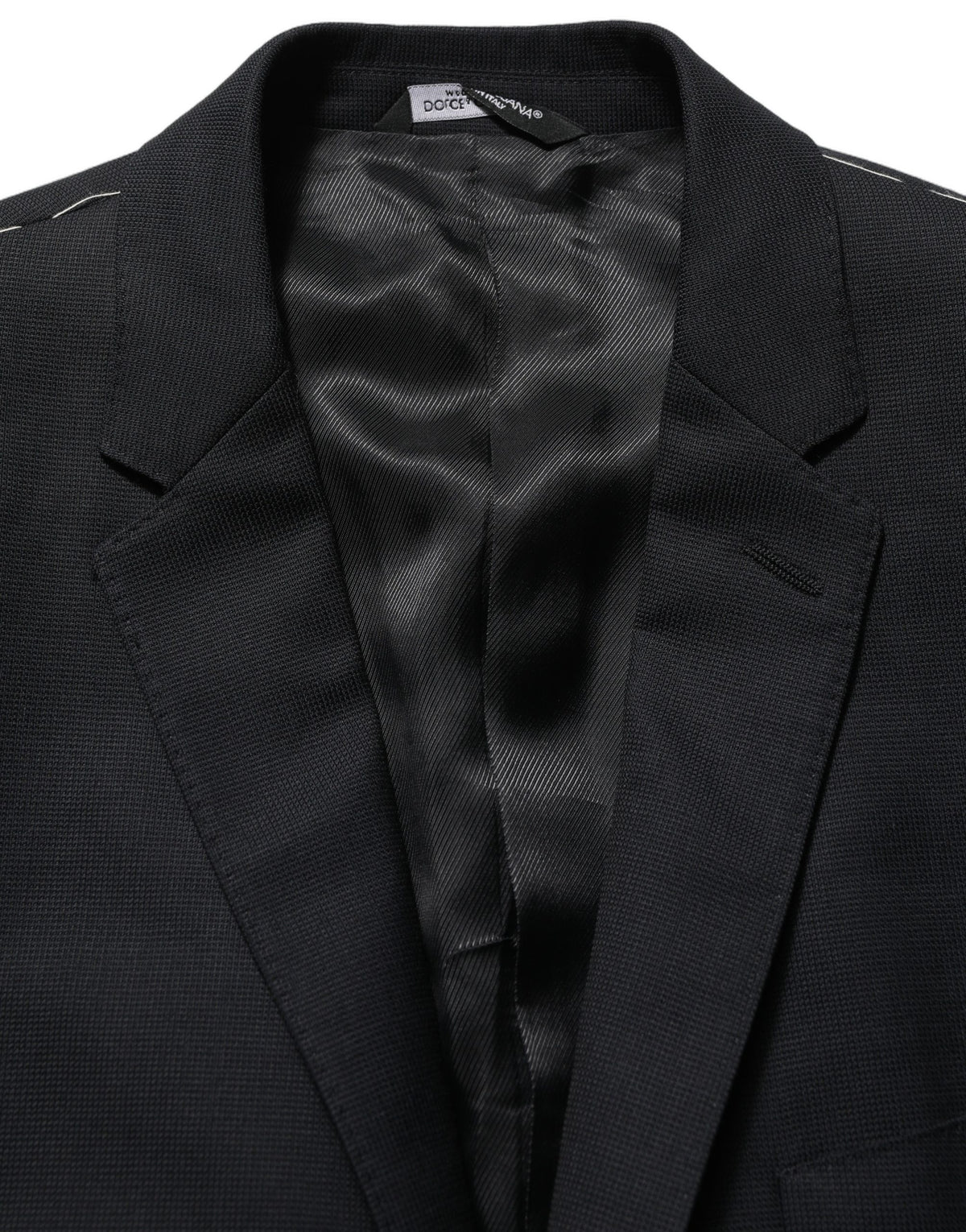 Dark blue wool Dolce & Gabbana single-breasted blazer jacket with notch lapels and button closure, tailored fit for a sophisticated look.