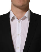 Black wool Dolce & Gabbana single-breasted blazer jacket with notch lapels and tailored fit, displayed on a hanger.