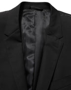 Dolce & Gabbana black wool single-breasted blazer jacket displayed on a hanger, showcasing tailored fit and classic style.