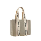 Chloé beige linen handbag with gold hardware and top handles, stylishly displayed on a neutral background.