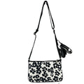 Michael Kors floral crossbody tech attachment bag with adjustable strap and spacious interior, designed for stylish convenience.