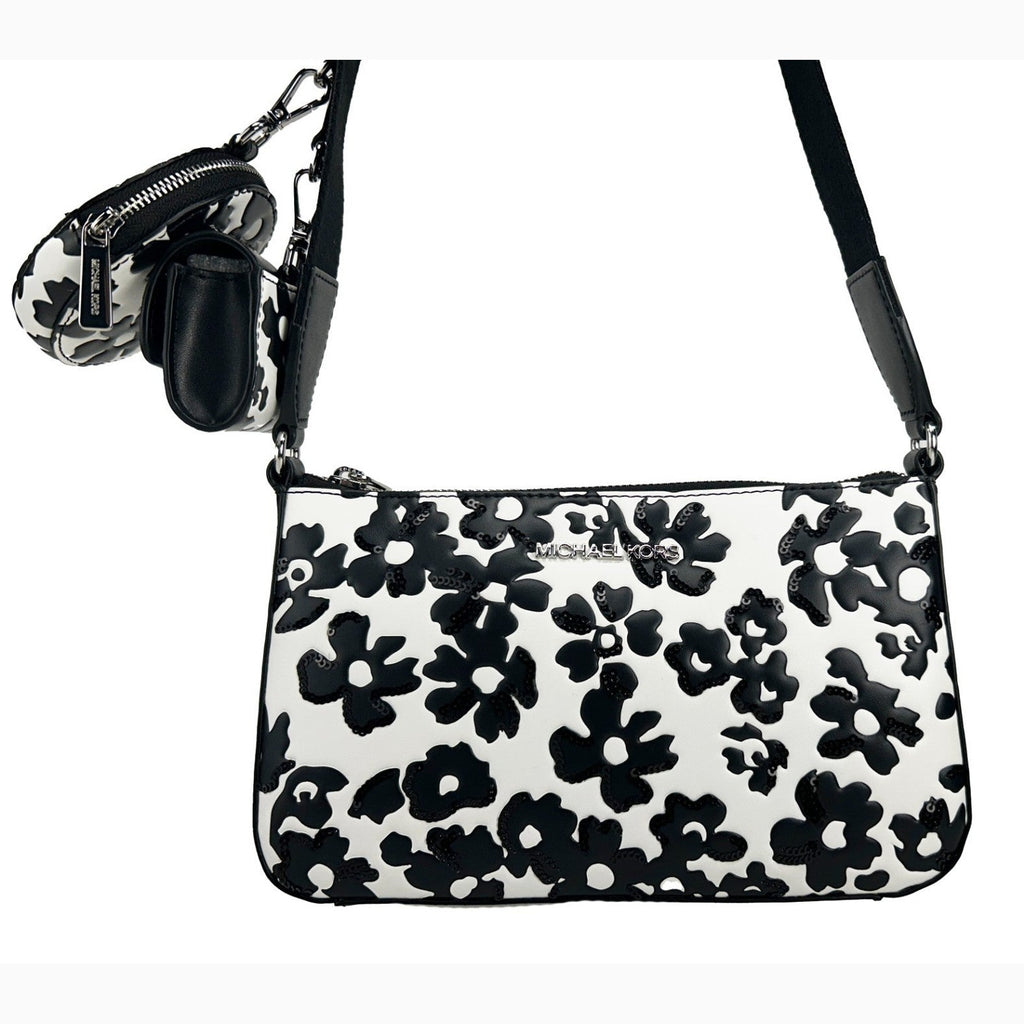 Michael Kors floral crossbody tech attachment bag with colorful floral design and adjustable strap, suitable for carrying small tech essentials.
