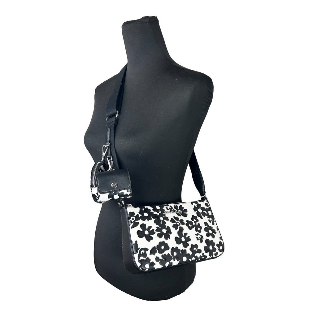 Michael Kors floral crossbody tech attachment bag featuring a colorful floral design and compact purse style.