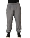 Gray cotton jogger sweatpants by Dolce & Gabbana with a relaxed fit and elastic waistband, shown on a mannequin.